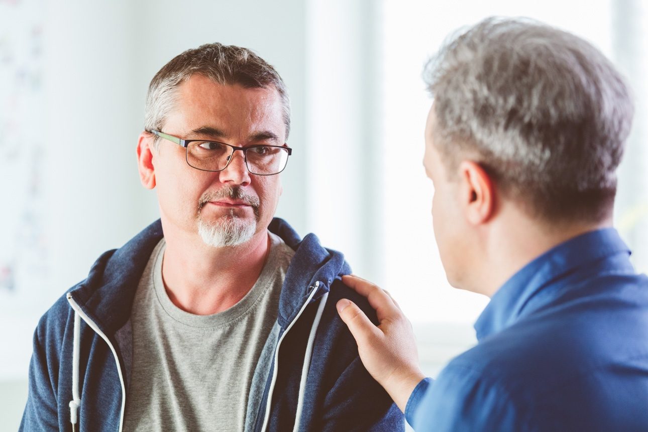 Image d'illustration présentant un homme apportant un soutien psychologique à un autre homme