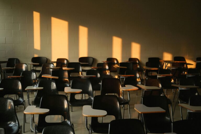 Rangée de chaises vides dans une salle de cours, symbolisant la baisse des inscriptions en théologie