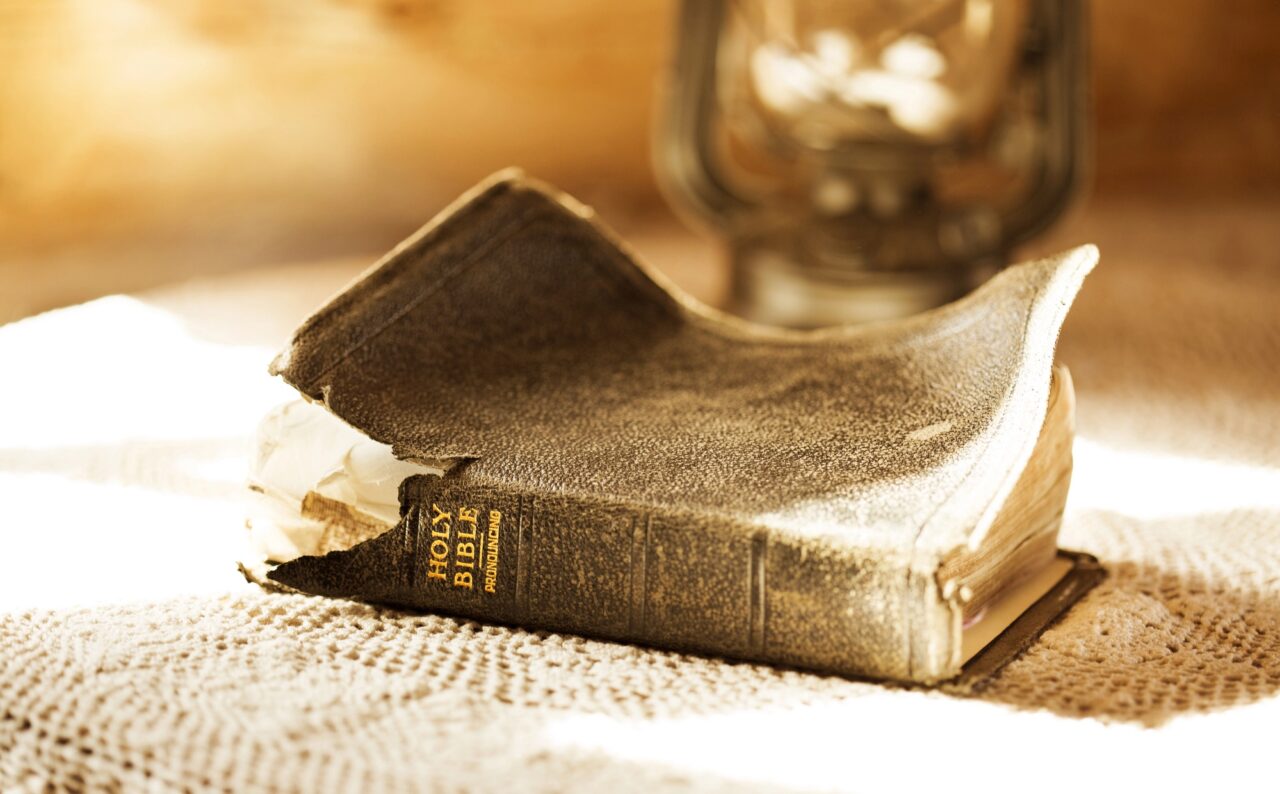 Vieille Bible à la couverture abîmée posée sur une table