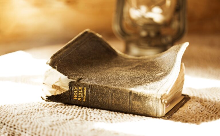 Vieille Bible à la couverture abîmée posée sur une table